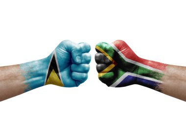 Two hands punch to each others on white background. Country flags painted fists, conflict crisis concept between saint lucia and south africa