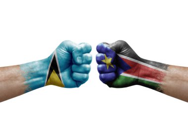 Two hands punch to each others on white background. Country flags painted fists, conflict crisis concept between saint lucia and south sudan