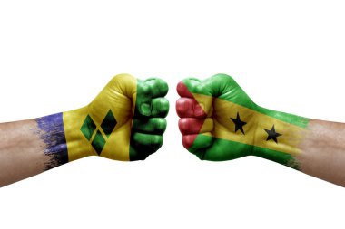 Two hands punch to each others on white background. Country flags painted fists, conflict crisis concept between saint vincent and the grenadines and sao tome and principe