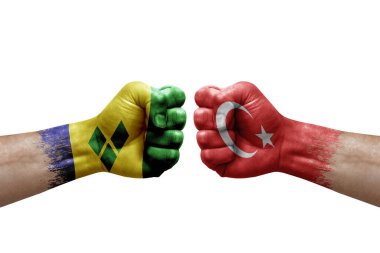 Two hands punch to each others on white background. Country flags painted fists, conflict crisis concept between saint vincent and the grenadines and turkey