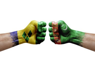 Two hands punch to each others on white background. Country flags painted fists, conflict crisis concept between saint vincent and the grenadines and turkmenistan