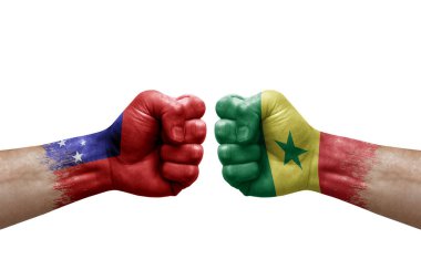 Two hands punch to each others on white background. Country flags painted fists, conflict crisis concept between samoa and senegal