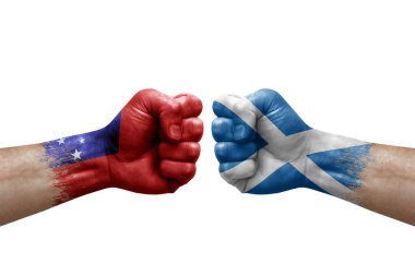 Two hands punch to each others on white background. Country flags painted fists, conflict crisis concept between samoa and scotland