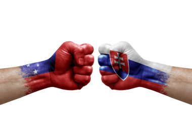Two hands punch to each others on white background. Country flags painted fists, conflict crisis concept between samoa and slovakia
