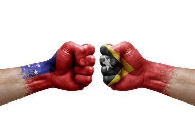 Two hands punch to each others on white background. Country flags painted fists, conflict crisis concept between samoa and timor leste