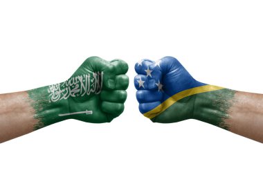 Two hands punch to each others on white background. Country flags painted fists, conflict crisis concept between saudi arabia and solomon islands