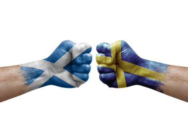 Two hands punch to each others on white background. Country flags painted fists, conflict crisis concept between scotland and sweden