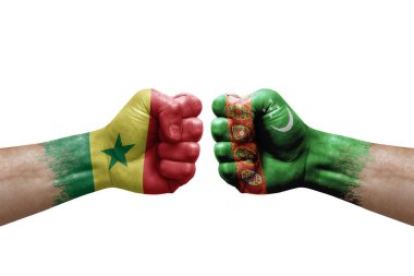 Two hands punch to each others on white background. Country flags painted fists, conflict crisis concept between senegal and turkmenistan