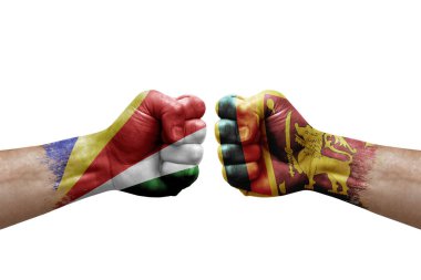 Two hands punch to each others on white background. Country flags painted fists, conflict crisis concept between seychelles and sri lanka