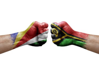 Two hands punch to each others on white background. Country flags painted fists, conflict crisis concept between seychelles and vanuatu