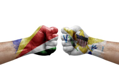 Two hands punch to each others on white background. Country flags painted fists, conflict crisis concept between seychelles and virgin islands