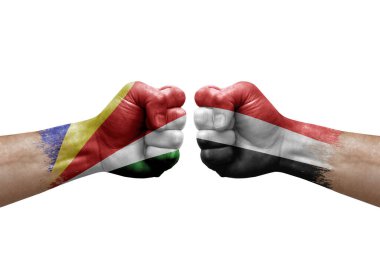 Two hands punch to each others on white background. Country flags painted fists, conflict crisis concept between seychelles and yemen