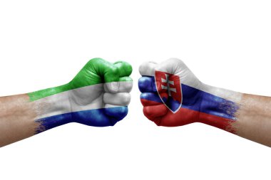 Two hands punch to each others on white background. Country flags painted fists, conflict crisis concept between sierra leone and slovakia