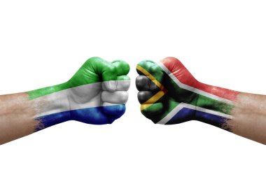 Two hands punch to each others on white background. Country flags painted fists, conflict crisis concept between sierra leone and south africa