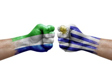 Two hands punch to each others on white background. Country flags painted fists, conflict crisis concept between sierra leone and uruguay