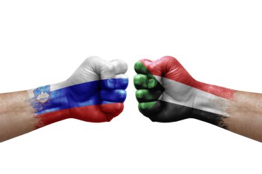 Two hands punch to each others on white background. Country flags painted fists, conflict crisis concept between slovenia and sudan
