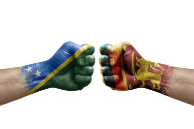 Two hands punch to each others on white background. Country flags painted fists, conflict crisis concept between solomon islands and sri lanka