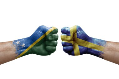 Two hands punch to each others on white background. Country flags painted fists, conflict crisis concept between solomon islands and sweden