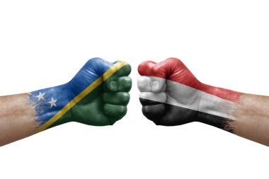 Two hands punch to each others on white background. Country flags painted fists, conflict crisis concept between solomon islands and yemen