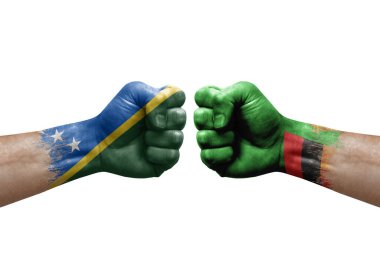 Two hands punch to each others on white background. Country flags painted fists, conflict crisis concept between solomon islands and zambia