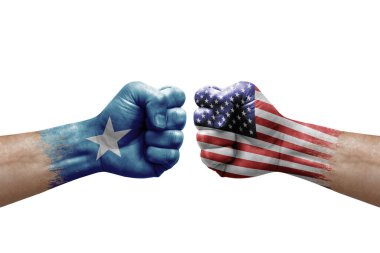 Two hands punch to each others on white background. Country flags painted fists, conflict crisis concept between somalia and usa