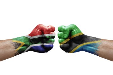 Two hands punch to each others on white background. Country flags painted fists, conflict crisis concept between south africa and tanzania