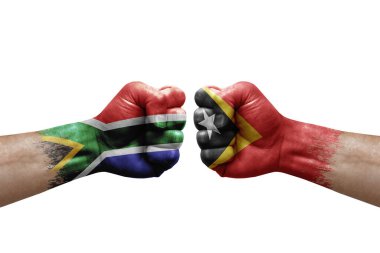 Two hands punch to each others on white background. Country flags painted fists, conflict crisis concept between south africa and timor leste