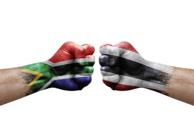 Two hands punch to each others on white background. Country flags painted fists, conflict crisis concept between south africa and thailand