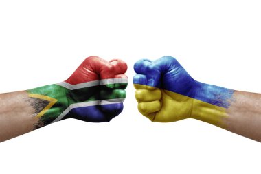 Two hands punch to each others on white background. Country flags painted fists, conflict crisis concept between south africa and ukraine