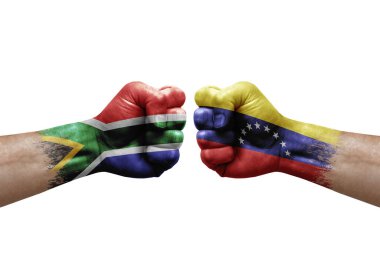 Two hands punch to each others on white background. Country flags painted fists, conflict crisis concept between south africa and venezuela