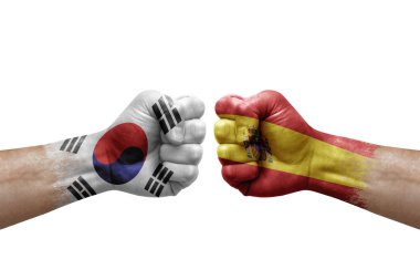 Two hands punch to each others on white background. Country flags painted fists, conflict crisis concept between south korea and spain
