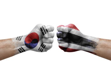 Two hands punch to each others on white background. Country flags painted fists, conflict crisis concept between south korea and thailand