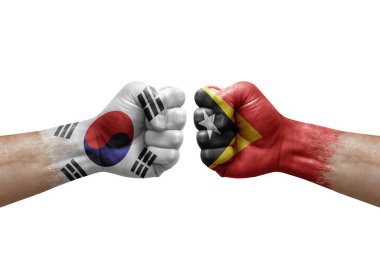 Two hands punch to each others on white background. Country flags painted fists, conflict crisis concept between south korea and timor leste