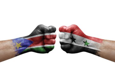 Two hands punch to each others on white background. Country flags painted fists, conflict crisis concept between south sudan and syria