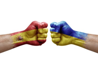 Two hands punch to each others on white background. Country flags painted fists, conflict crisis concept between spain and ukraine