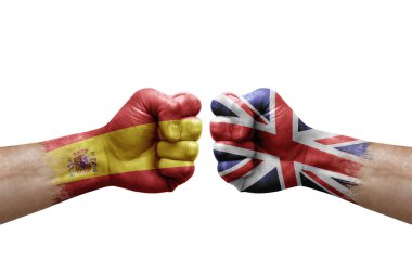 Two hands punch to each others on white background. Country flags painted fists, conflict crisis concept between spain and united kingdom