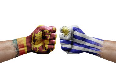 Two hands punch to each others on white background. Country flags painted fists, conflict crisis concept between sri lanka and uruguay