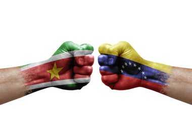 Two hands punch to each others on white background. Country flags painted fists, conflict crisis concept between suriname and venezuela