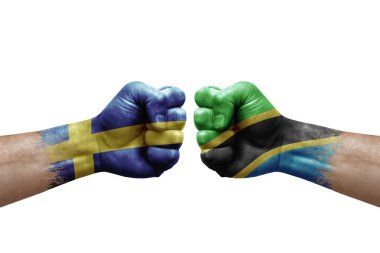 Two hands punch to each others on white background. Country flags painted fists, conflict crisis concept between sweden and tanzania