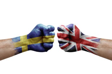 Two hands punch to each others on white background. Country flags painted fists, conflict crisis concept between sweden and united kingdom