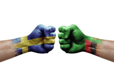 Two hands punch to each others on white background. Country flags painted fists, conflict crisis concept between sweden and zambia