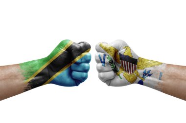 Two hands punch to each others on white background. Country flags painted fists, conflict crisis concept between tanzania and virgin islands
