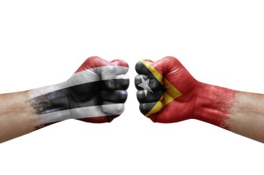 Two hands punch to each others on white background. Country flags painted fists, conflict crisis concept between thailand and timor leste