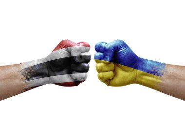 Two hands punch to each others on white background. Country flags painted fists, conflict crisis concept between thailand and ukraine