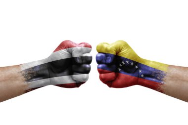 Two hands punch to each others on white background. Country flags painted fists, conflict crisis concept between thailand and venezuela