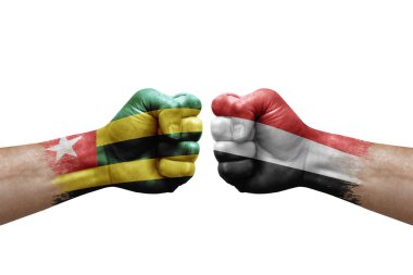 Two hands punch to each others on white background. Country flags painted fists, conflict crisis concept between togo and yemen
