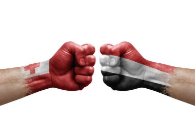 Two hands punch to each others on white background. Country flags painted fists, conflict crisis concept between tonga and yemen