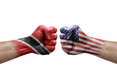 Two hands punch to each others on white background. Country flags painted fists, conflict crisis concept between trinidad tobago and usa