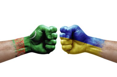 Two hands punch to each others on white background. Country flags painted fists, conflict crisis concept between turkmenistan and ukraine
