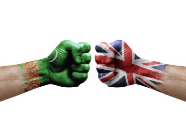 Two hands punch to each others on white background. Country flags painted fists, conflict crisis concept between turkmenistan and united kingdom